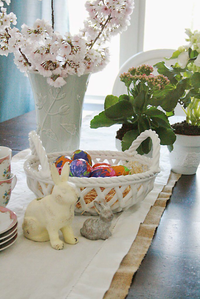 easter eggs decorating and table with spring flowers