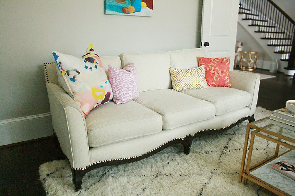 colorful pillows on white sofa in office setting modern meets vintage sofa shape