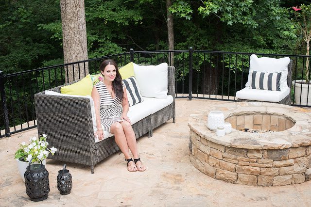 white sectional, black and white outdoor, stone patio, fire pit, backyard landscaping