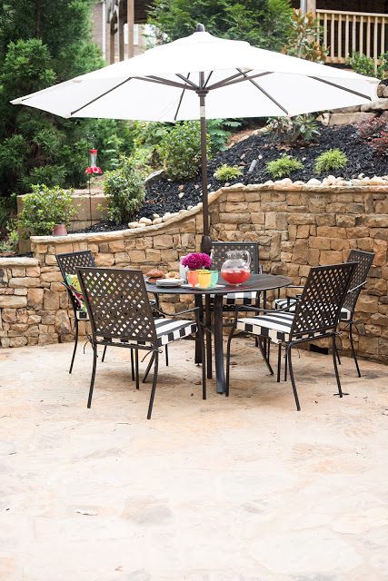 stone patio table and chairs, black and white outdoor, plants, backyard, landscaping