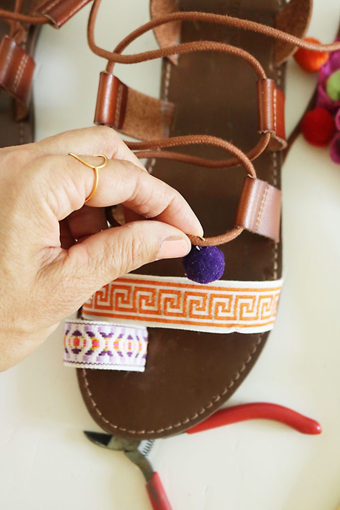 DIY-pom-pom-sandals-putting-on-pom