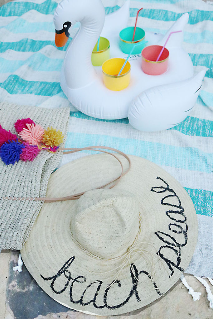 diy-word-script-straw-hat-at-pool, beach hat diy, diy summer project, straw beach hat, summer party favors, eugenia kim beach hat, script hat, phrase hat, beach straw hat