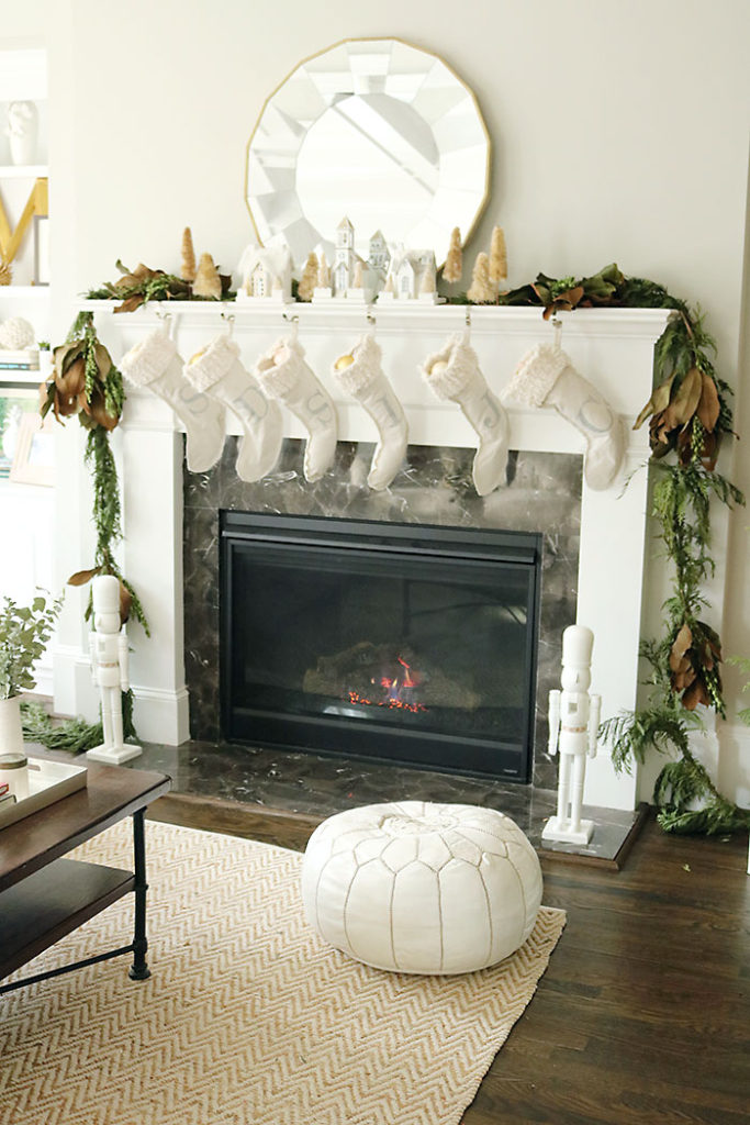 christmas-decorations-stocking-hung-by-chimney, christmas-decorations-living-room-shot, fireplace mantle christmas decorations, magnolia garland, winter white christmas, living room christmas decorations