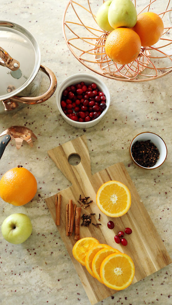 christmas stovetop potpourri, the smell of christmas, christmas aroma, orange slices, cloves, cinnamon sticks, orange balls with cloves, copper pan, cranberries, christmas stovetop potpourris 