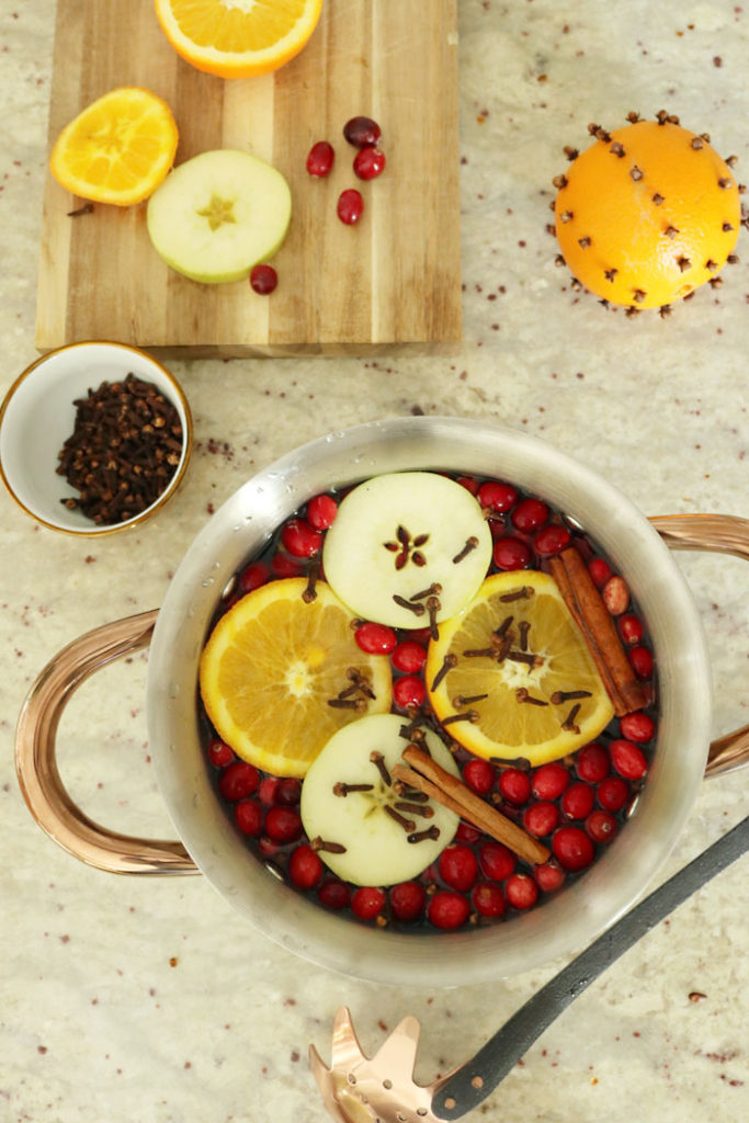 christmas stovetop potpourri, the smell of christmas, christmas aroma, orange slices, cloves, cinnamon sticks, orange balls with cloves, copper pan