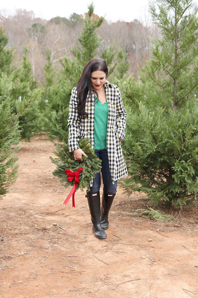 cutting-christmas-tree-down-with-wreath