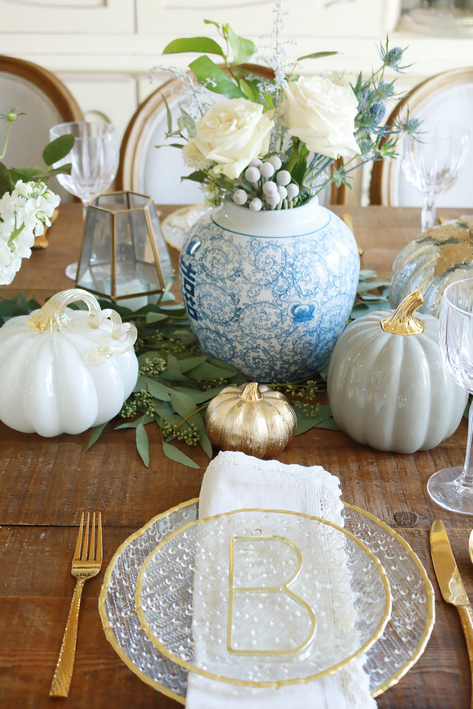 elegant thanksgiving table setting, chic thanksgiving table decorations, table setting pumpkins, thanksgiving flowers, thanksgiving geometric candle hurricane lanterns, gold table setting, thanksgiving tablescape, thanksgiving elegant rustic decorations, thanksgiving ideas, home goods table, pumpkin centerpieces, white pumpkin, thanksgiving dining room, beautiful thanksgiving, martha Stewart