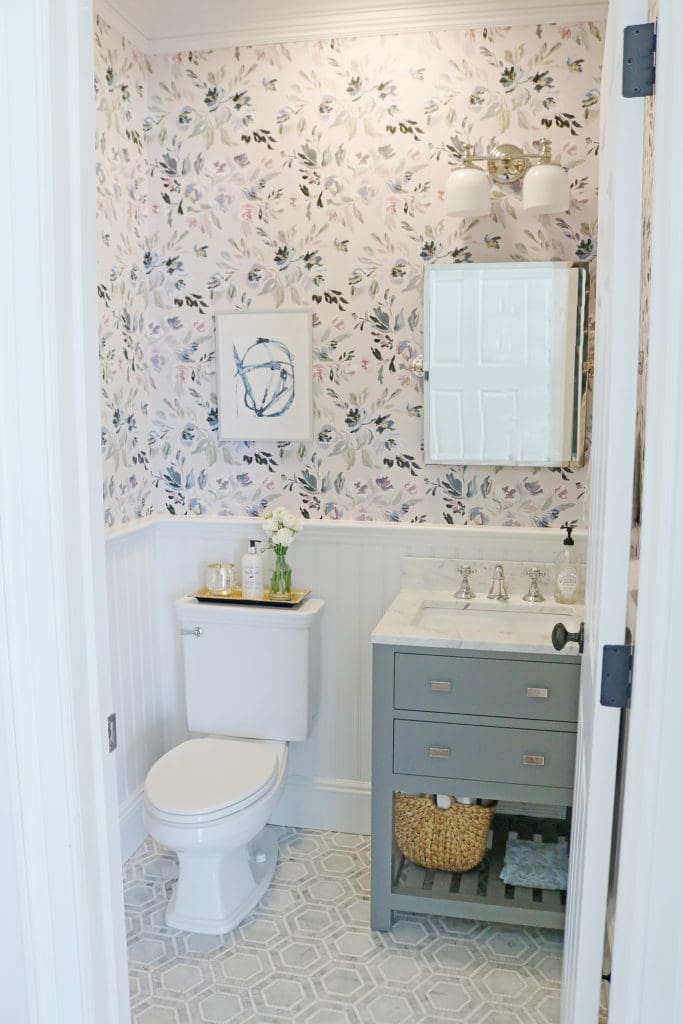 I am so excited to reveal our Powder Bathroom Makeover!  The before and after transformation is amazing!  We used Thassos mosaic Marble tile, Caitlin Wilson Design Wallpaper, Wayfair bathroom vanity, Pottery Barn bathroom fixtures. The Powder bathroom makeover has a modern, farmhouse but elegant style with navy and gray accents. || Darling Darleen #darlingdarleen #powderbathroom #mosaictile