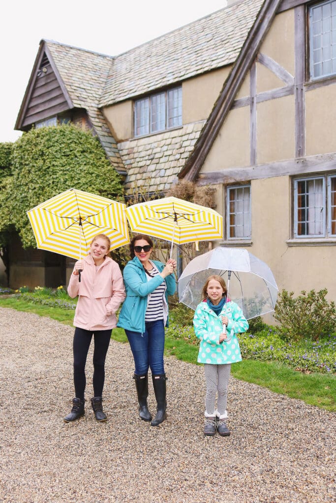 Exploring Topsmead State Forest and the beautiful Tudor-style country home with these two ladies, and dressed in our spring rain jackets to stay dry with the help of these cute yellow umbrellas! || Darling Darleen Top Connecticut Lifestyle Blogger