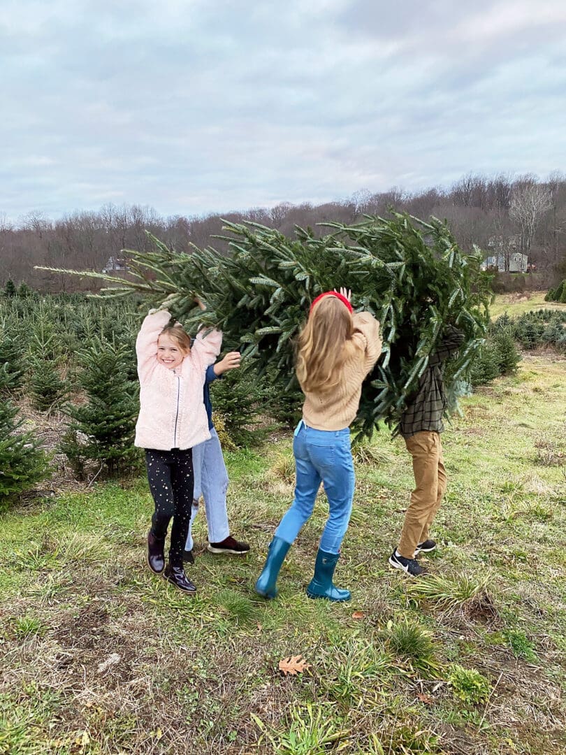 Our annual family tradition brings us to the Christmas Tree farm to find the perfect Christmas tree to cut down and bring home to decorate! Cutting down Christmas Tree.  Christmas tree cutting outfits || Darling Darleen Top Lifestyle Blogger 