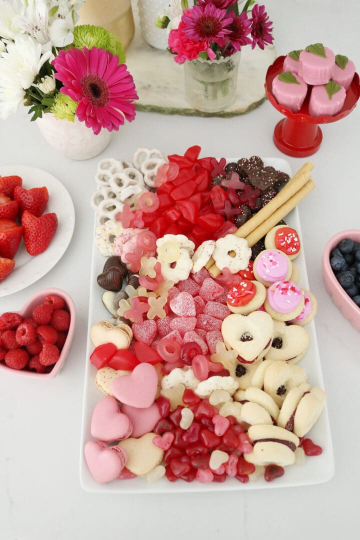 Bring Valentine's Day Home this year!  Put together a Valentine's charcuterie board with heart shaped chocolate, cinnamon lips and macrons!  So many fun Valentine's Day ideas to share with your family || Darling Darleen Top Lifestyle Blogger #ctblogger #darlingdarleen #valentinesday