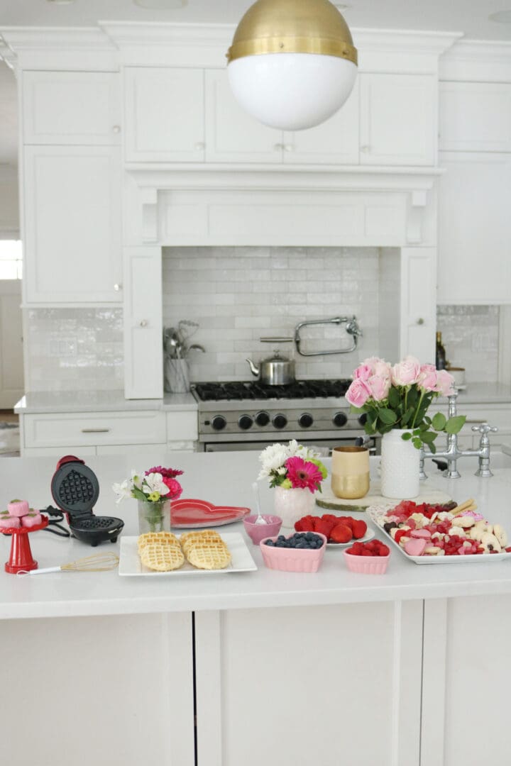 Bring Valentine's Day Home this year!  Put together a Valentine's waffle bar and breakfast of hearts and a charcuterie board with heart shaped chocolate, cinnamon lips and macrons!  So many fun Valentine's Day ideas to share with your family || Darling Darleen Top Lifestyle Blogger #ctblogger #darlingdarleen #valentinesday